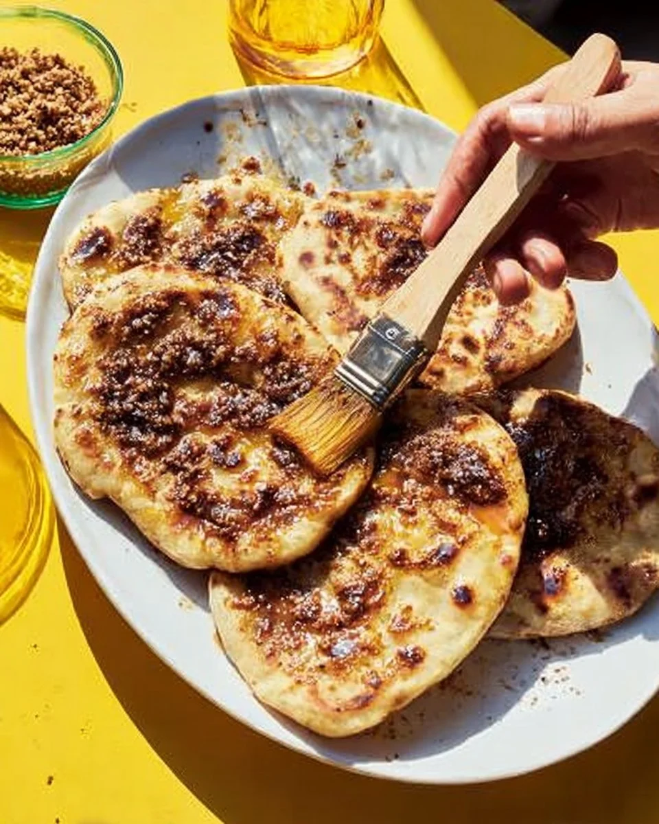 Freshly baked olive oil flatbreads on a rustic wooden table